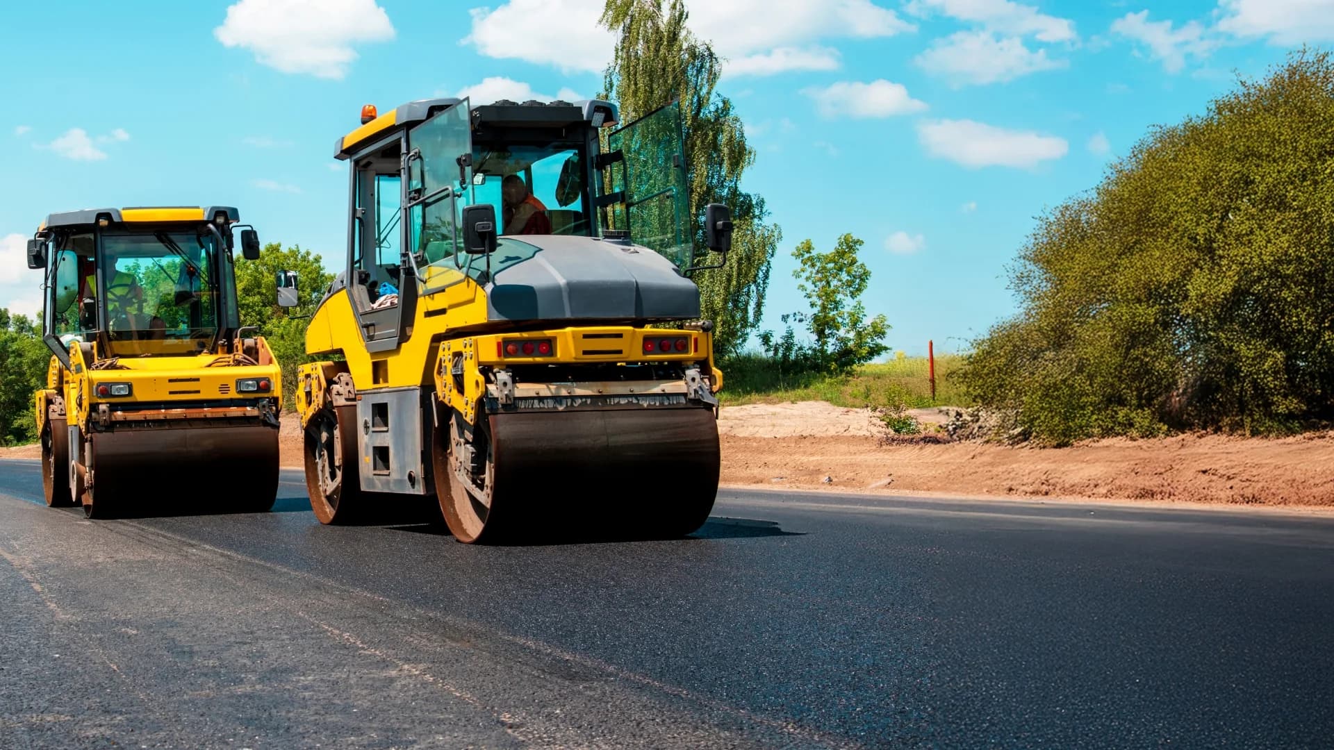 Asphalt rollers paving a fresh road surface